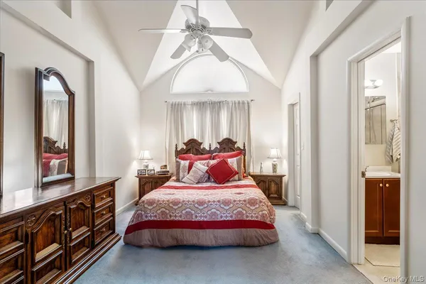 a bedroom with a large bed and a chandelier