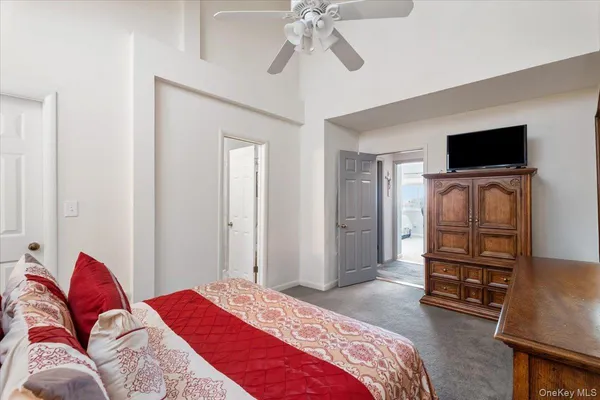 a bedroom with a bed and a television