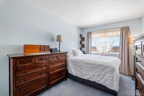 a bedroom with a bed and a tv on top of it