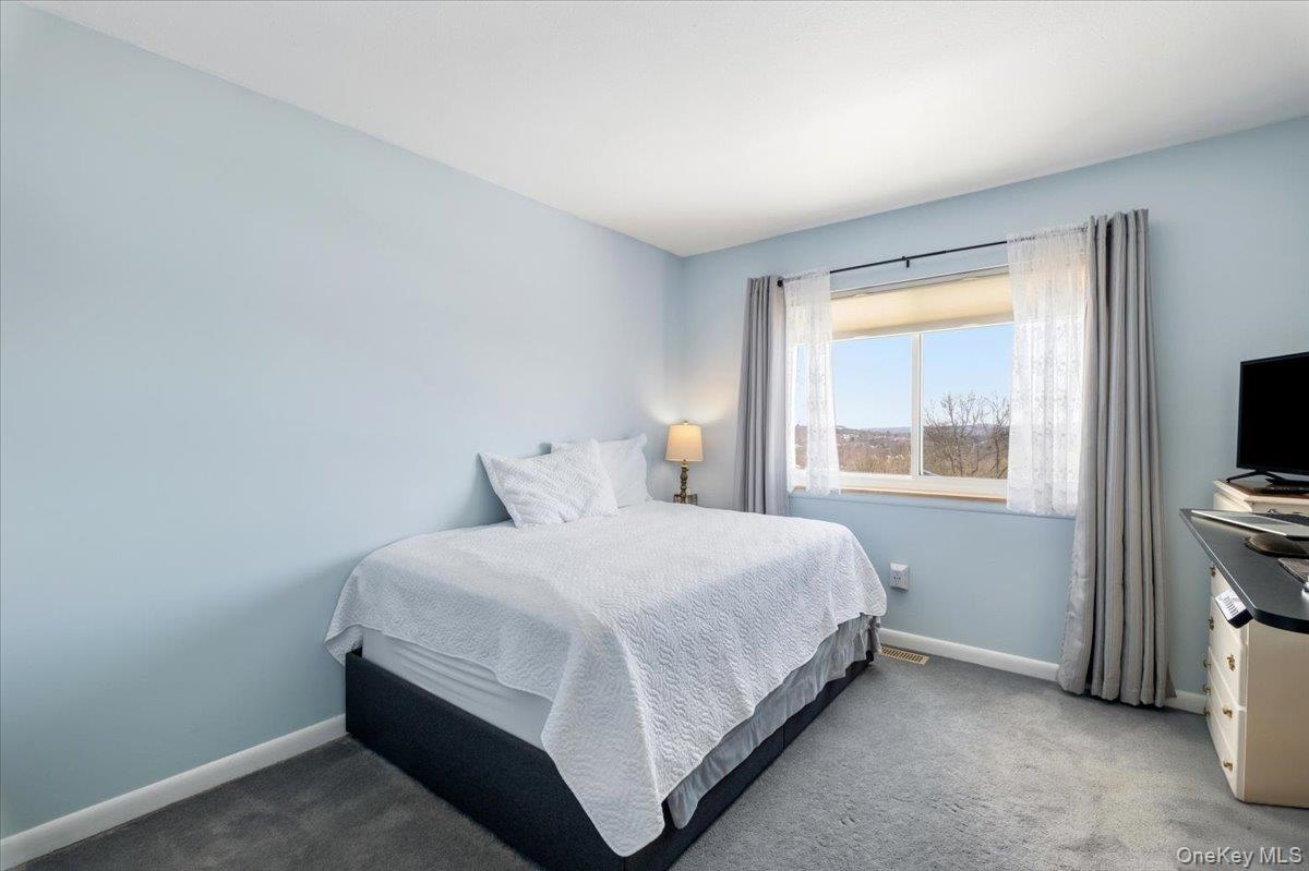 1707 Eagles Ridge Road Brewster, NY 10509 - Photo 27 of 50 a bedroom with a bed and a flat tv screen on a dresser