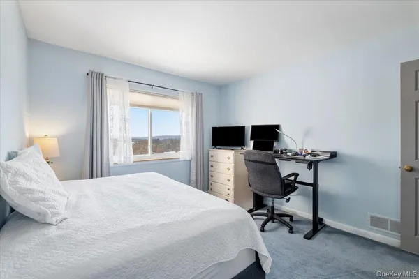 a bedroom with a bed and a desk