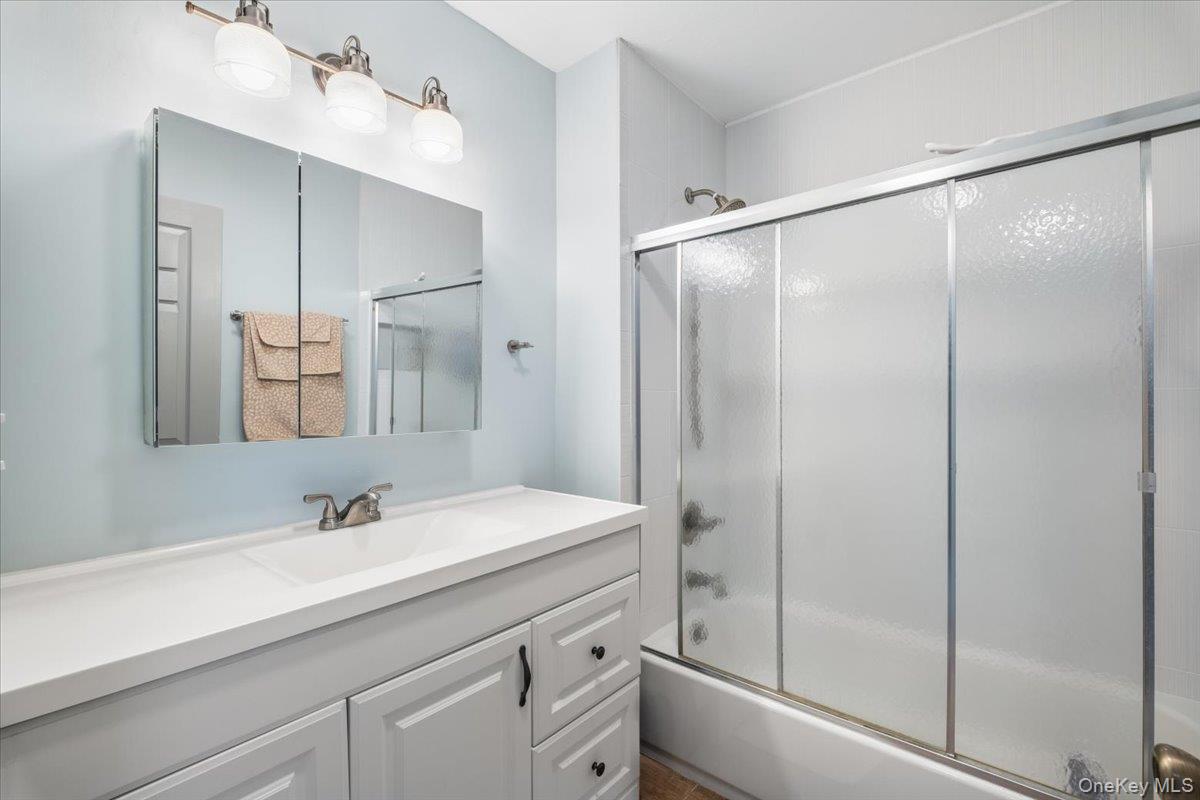 1707 Eagles Ridge Road Brewster, NY 10509 - Photo 30 of 50 a bathroom with a shower sink vanity and mirror