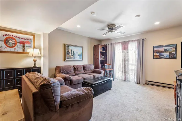 a living room with furniture ceiling fan and a rug