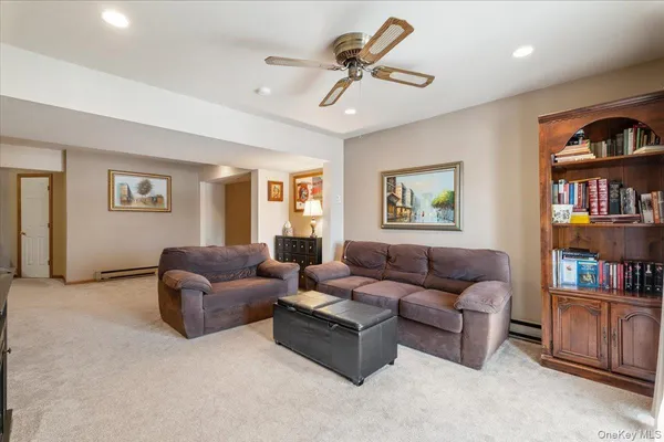 a living room with furniture and a book shelf