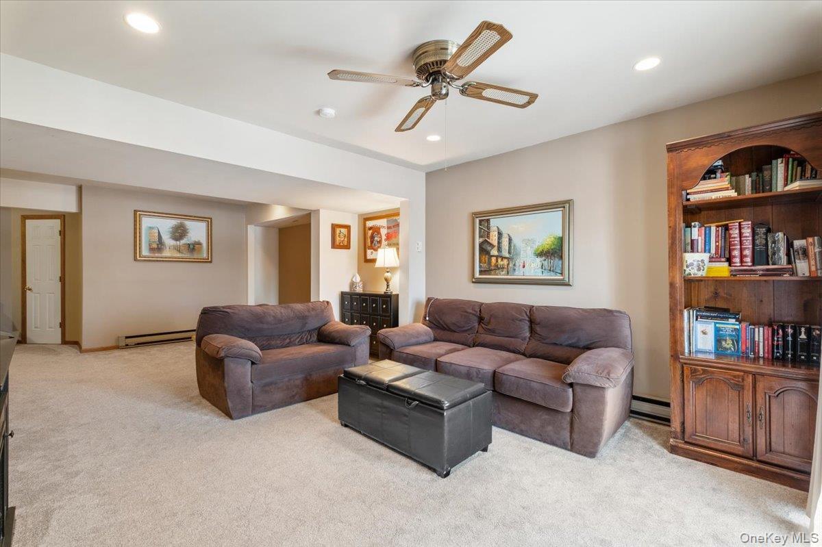 1707 Eagles Ridge Road Brewster, NY 10509 - Photo 35 of 50 a living room with furniture and a book shelf