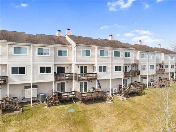 a view of a large building with swimming pool and sitting area