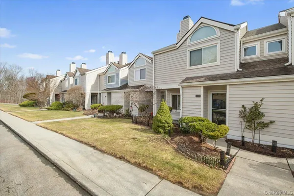 a view of a house with a yard and sitting area