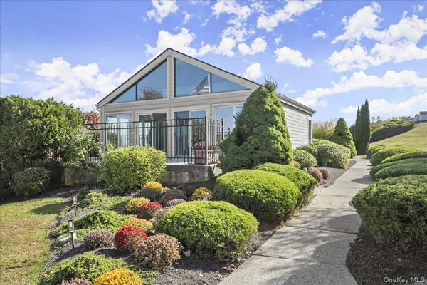 a front view of house with lot of plants