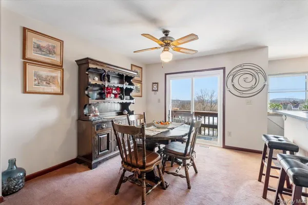 a view of a dining room with furniture and window