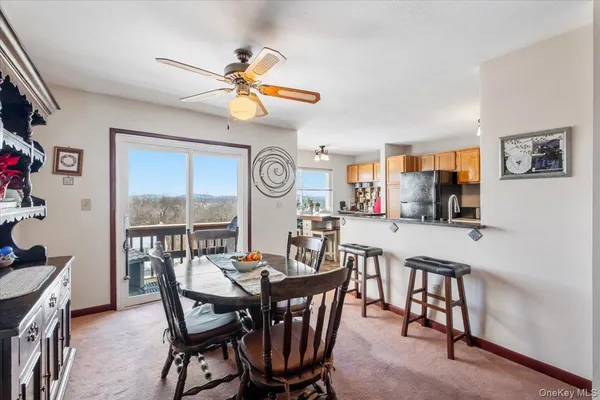 a view of a dining room with furniture and a chandelier