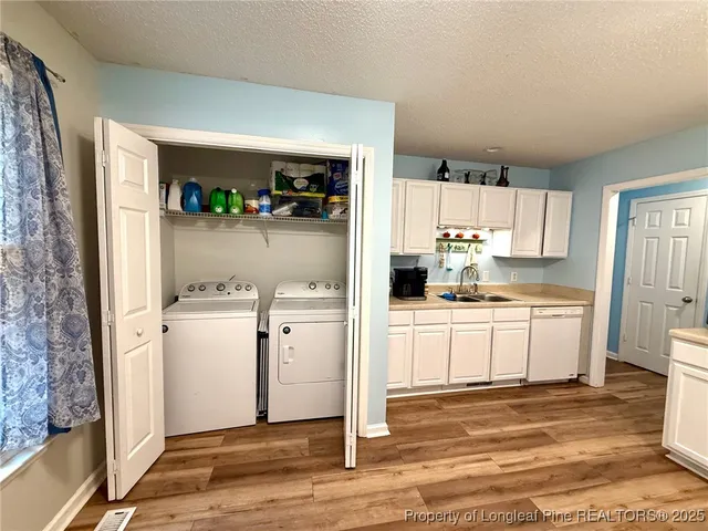 a kitchen with refrigerator and cabinets