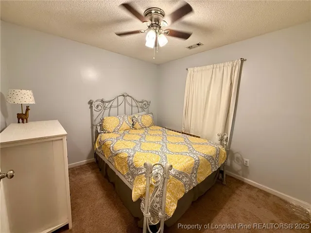 a bed sitting in a bedroom next to a bathroom