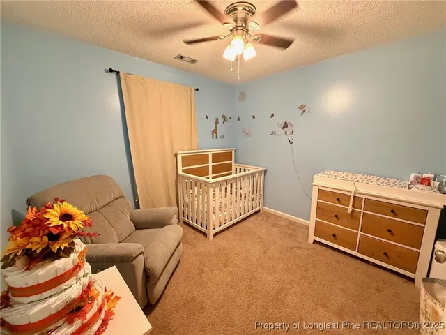 a living room with furniture cabinets and window