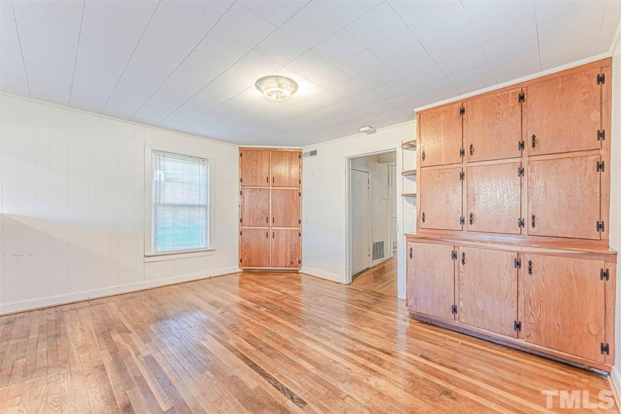 420 County Line Road Timberlake, NC 27583 - Photo 14 of 30 an empty room with wooden floor cabinet and windows