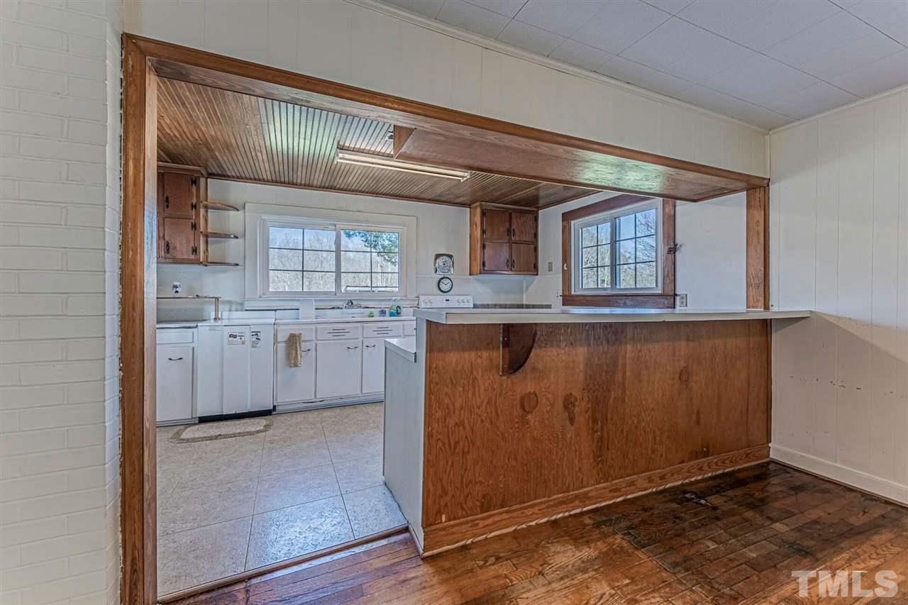420 County Line Road Timberlake, NC 27583 - Photo 16 of 30 a kitchen with kitchen island granite countertop a stove and a sink