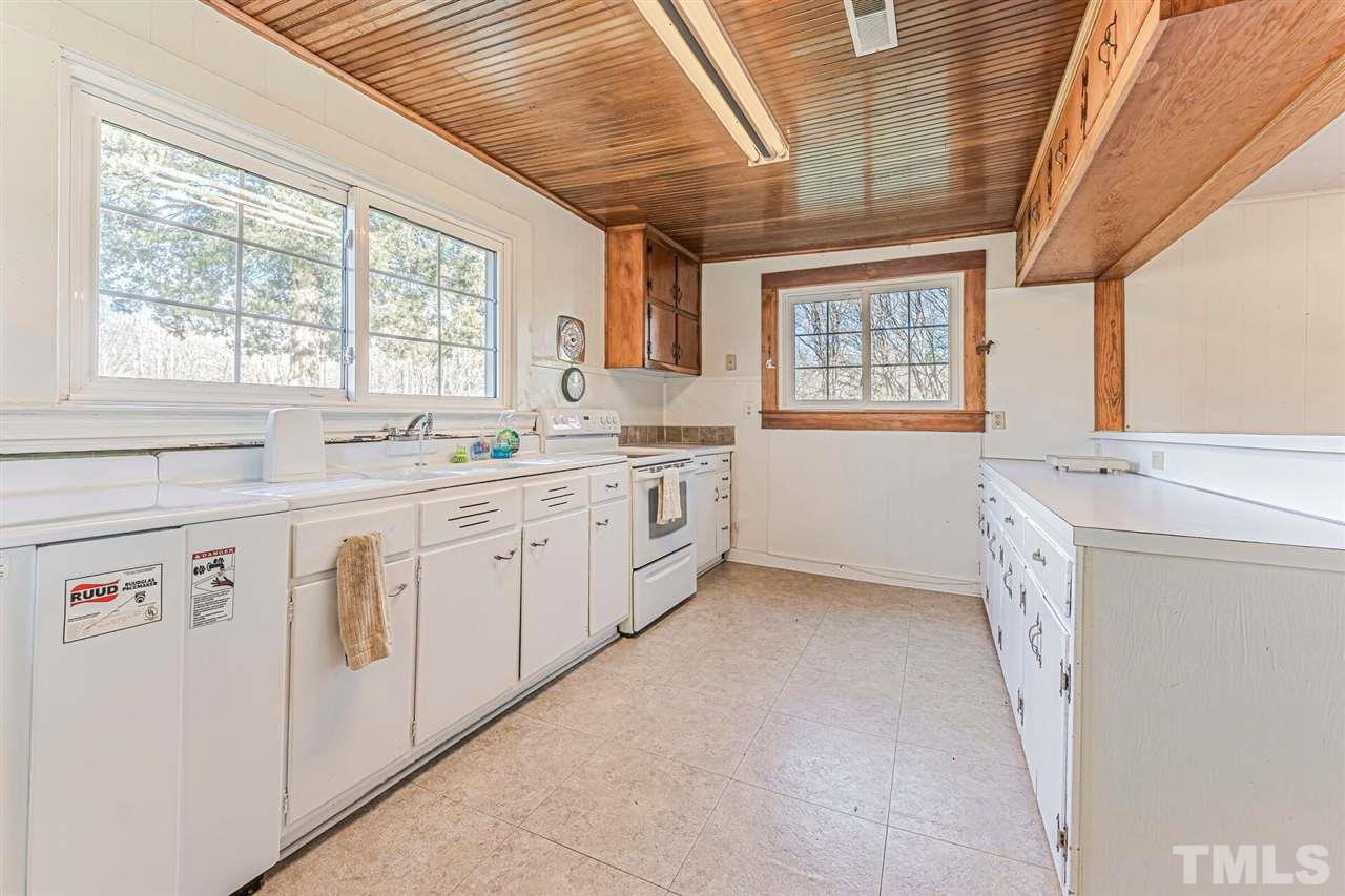 420 County Line Road Timberlake, NC 27583 - Photo 19 of 30 a kitchen with white cabinets and white appliances