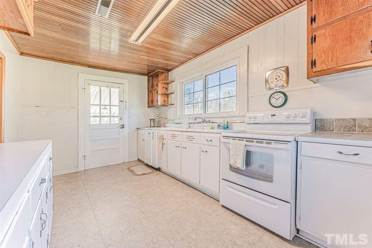 420 County Line Road Timberlake, NC 27583 - Photo 20 of 30 a kitchen with white cabinets and white appliances