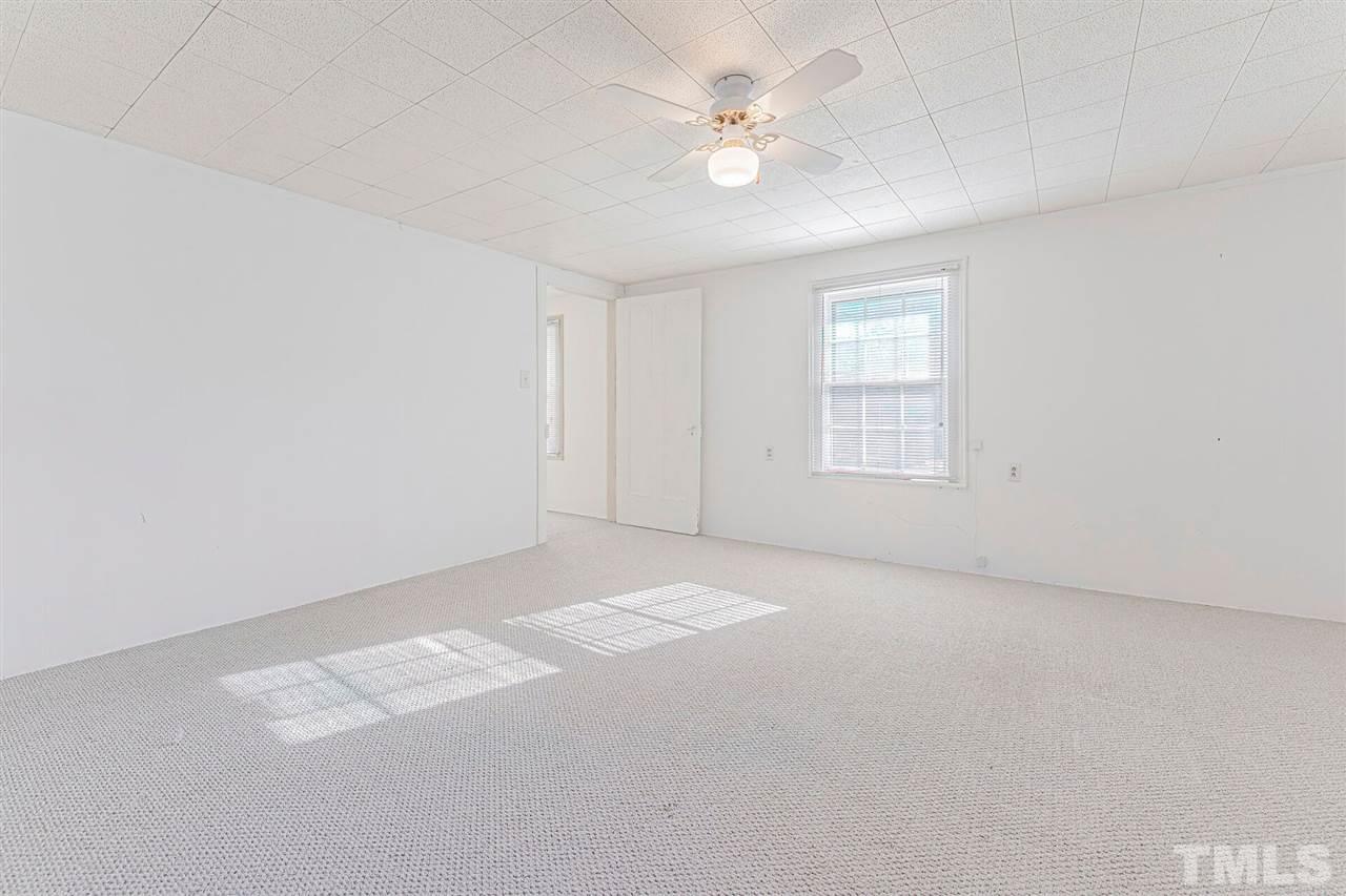 420 County Line Road Timberlake, NC 27583 - Photo 23 of 30 an empty room with windows and ceiling fan