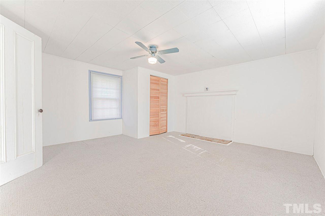 420 County Line Road Timberlake, NC 27583 - Photo 24 of 30 an empty room with a ceiling fan and a window