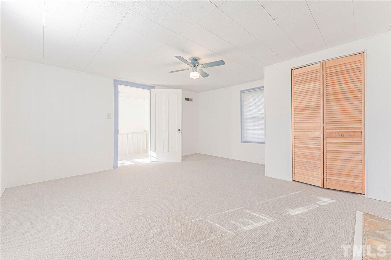 420 County Line Road Timberlake, NC 27583 - Photo 25 of 30 an empty room with a ceiling fan and a window