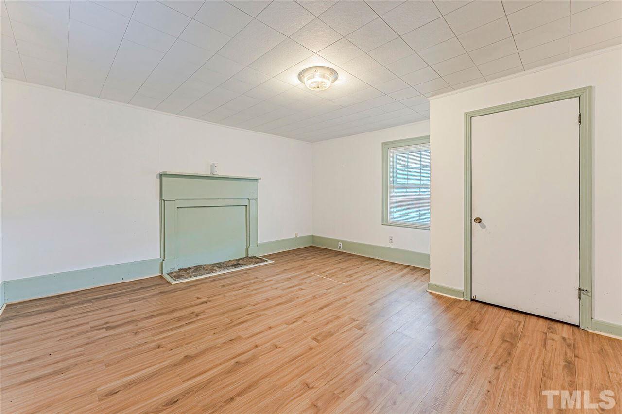 420 County Line Road Timberlake, NC 27583 - Photo 7 of 30 an empty room with wooden floor and windows