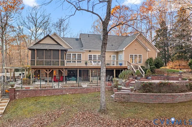a view of a yard in front of a house with large trees