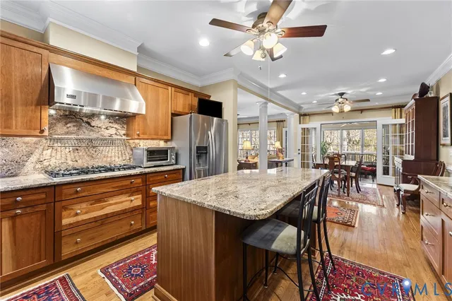 a large kitchen with a table and chairs