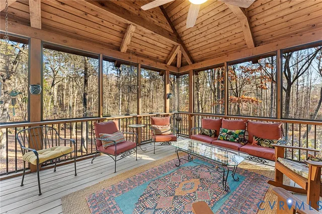 a living room with furniture fireplace and a large window