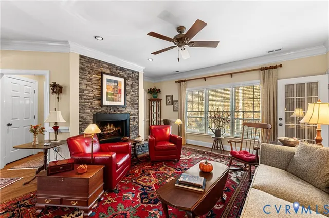 a living room with furniture fireplace and a large window