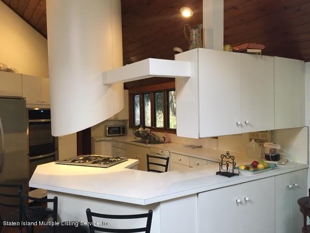 775 Todt Hill Road Staten Island, NY 10304 - Photo 2 of 4 a kitchen with a sink a stove and refrigerator