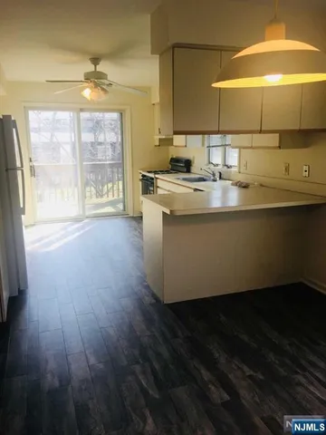 a room with wooden floor and a sink