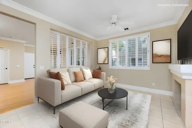 a living room with furniture and floor to ceiling windows