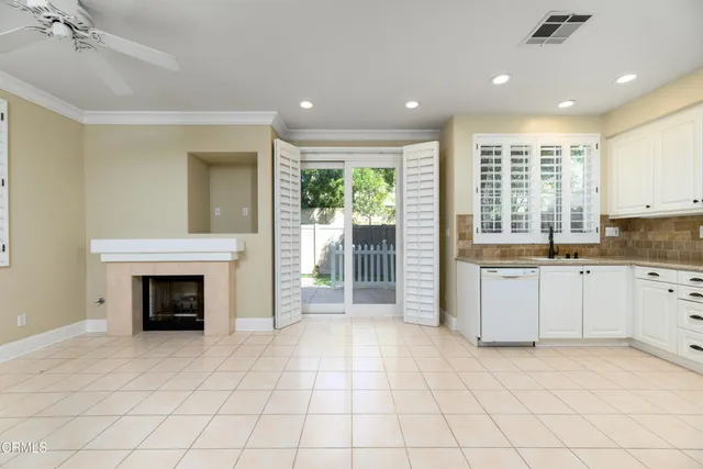 a kitchen with granite countertop white cabinets stainless steel appliances and a sink