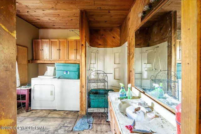 a bathroom with a granite countertop toilet a sink and a mirror