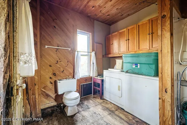 a view of a room with wooden floor and furniture