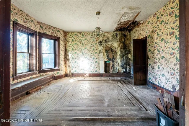 wooden floor in an empty room with a window
