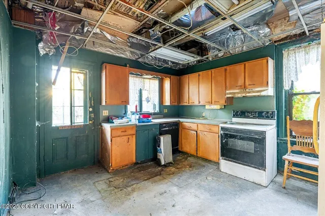 a kitchen with window and stainless steel appliances