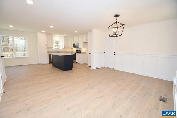 a view of a kitchen with a sink and dishwasher cabinet with wooden floor