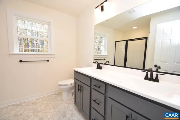 a bathroom with a sink a toilet and mirror