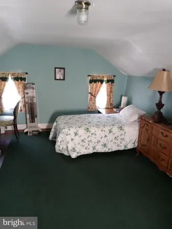 a bedroom with a bed and dresser