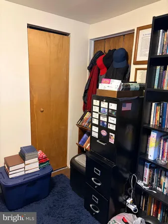 a living room with furniture and a book shelf