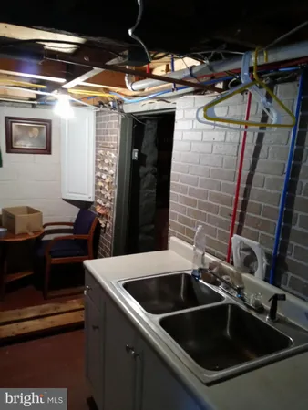 a kitchen with a sink and stainless steel appliances