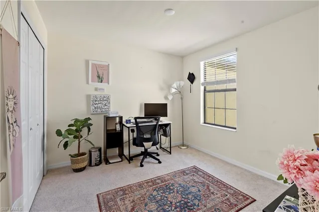 a workspace room with furniture and a window