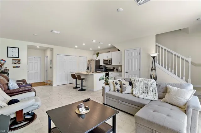 a kitchen with stainless steel appliances a stove a refrigerator a sink and a refrigerator