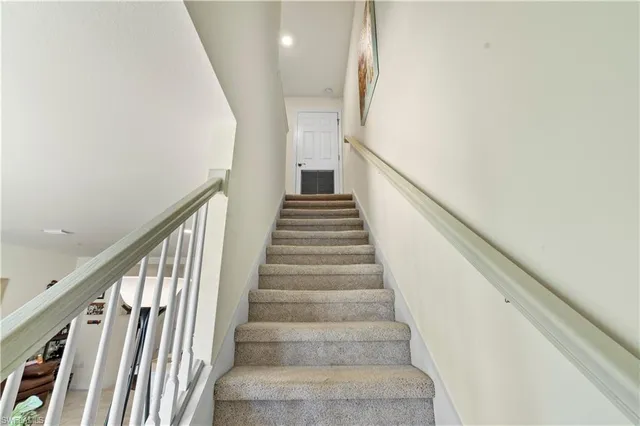a living room with furniture a rug and white walls