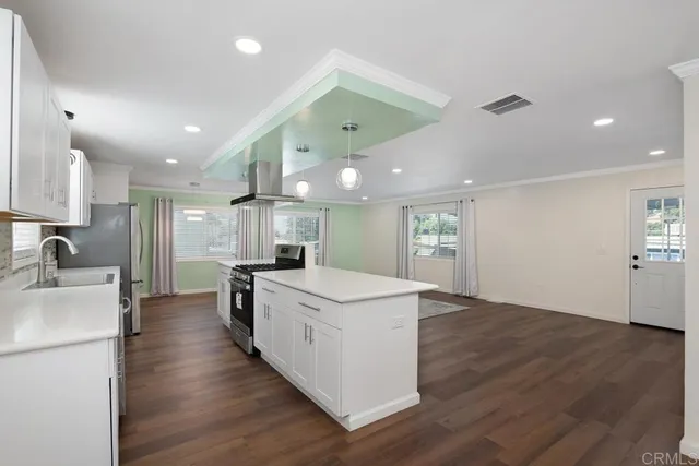 a kitchen with a stove a sink and a refrigerator