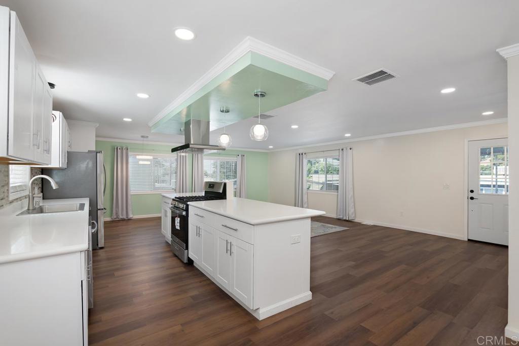 a kitchen with a stove a sink and a refrigerator