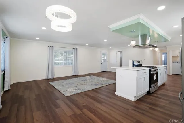a view of kitchen with cabinets and wooden floor