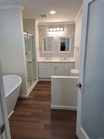 a bathroom with a sink mirror and a bathtub