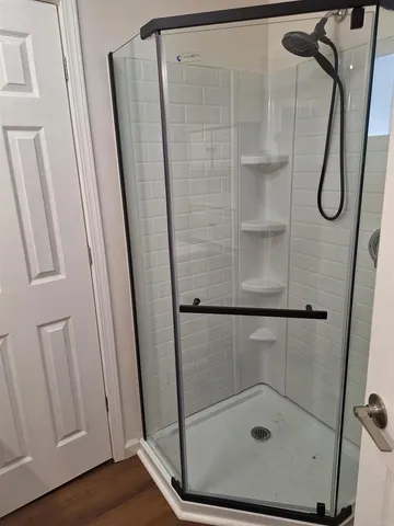 a bathroom with a glass shower door